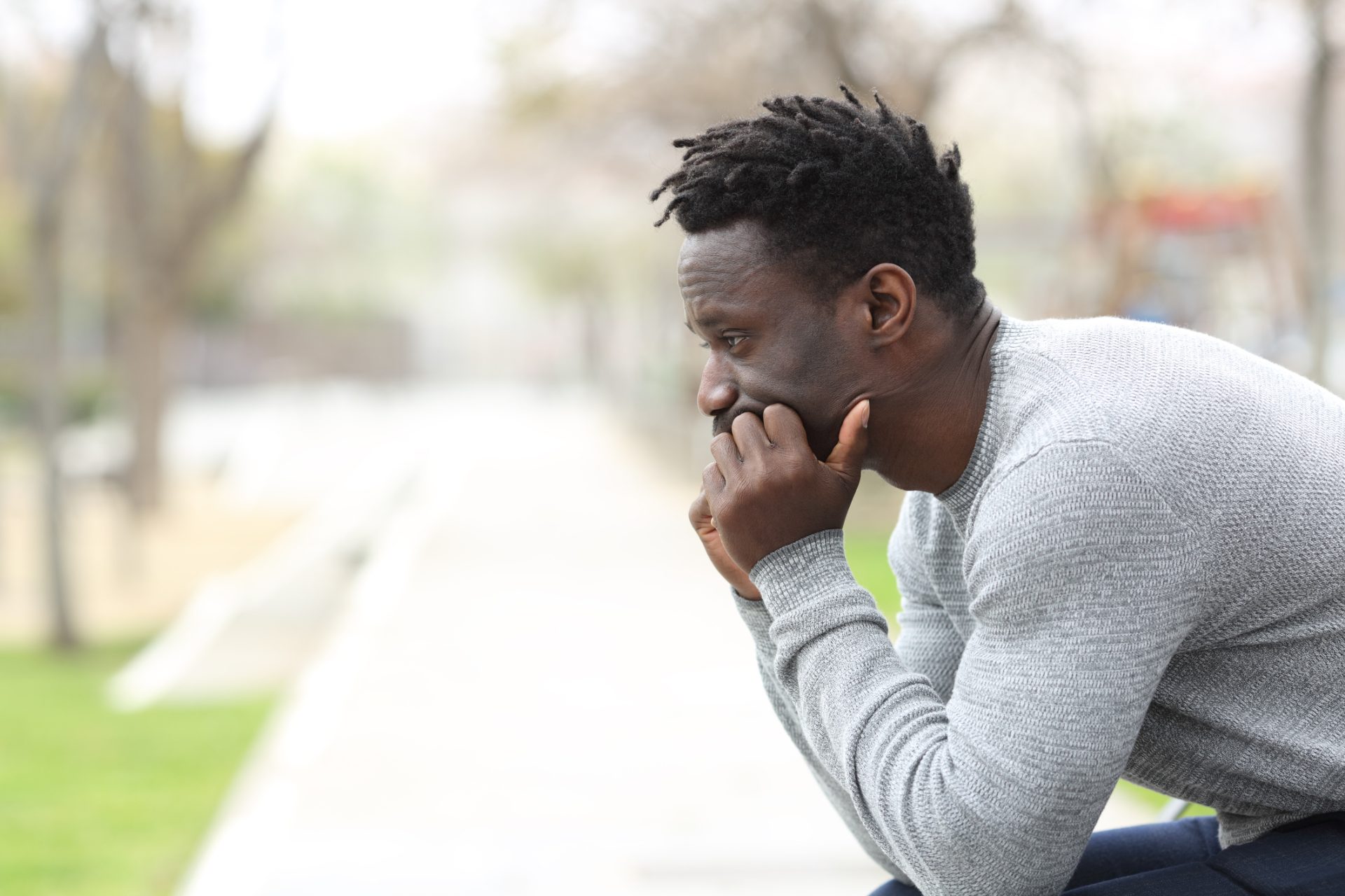 A man resting his head in his hands, looking very thoughtful