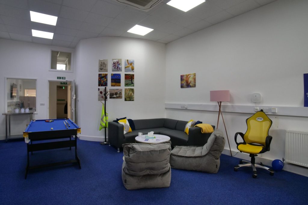 the photo shows an inside room from our Hatfield crisis cafe, including a pool table, sofa, kitchen area and chairs